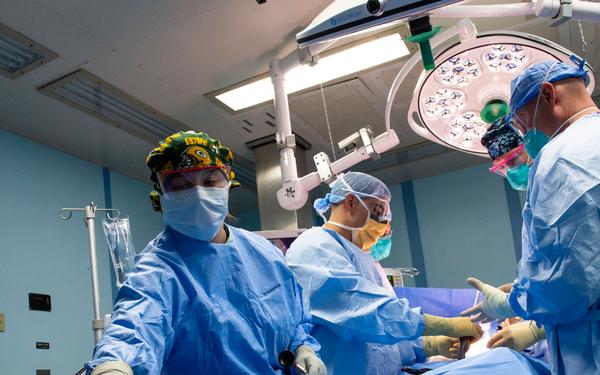 USNS Mercy Sailors Perform Surgery