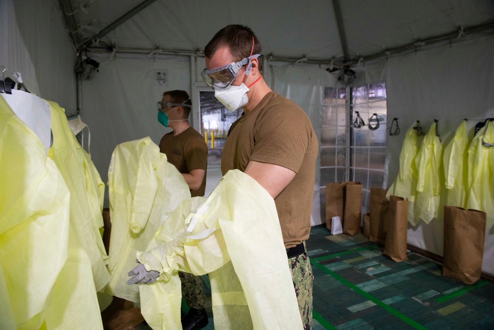 Patient Transport Team Receives Patients Arriving for Medical Care Aboard the Military Sealift Command hospital ship USNS Comfort (T-AH 20)