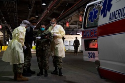 Patient Transport Team Receives Patients Arriving for Medical Care Aboard the Military Sealift Command hospital ship USNS Comfort (T-AH 20)