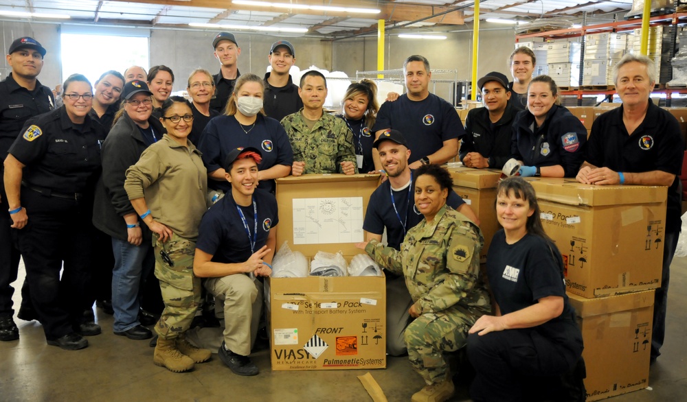 Volunteers and Military personnel work together to ship 500 ventilators to various states