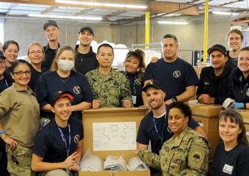 Volunteers and Military personnel work together to ship 500 ventilators to various states