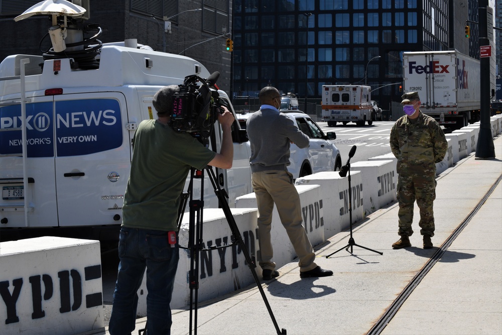 Media members speak to New York National Guard members
