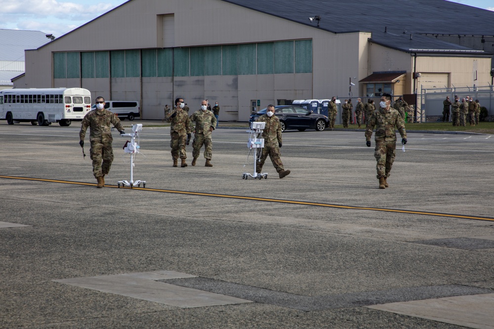 Members of the Massachusetts Army National Guard assist with medical screenings