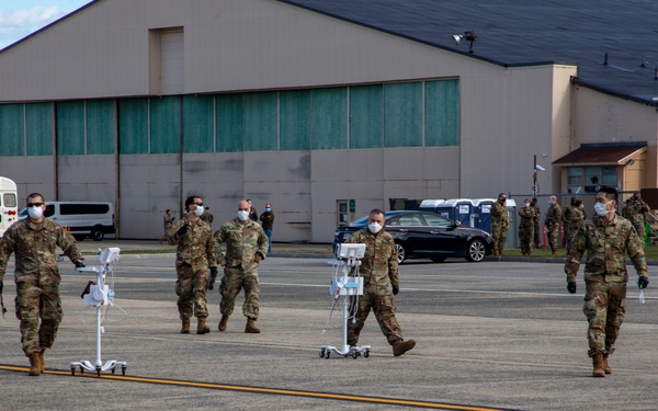 Members of the Massachusetts Army National Guard assist with medical screenings