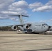 Members of The 801st Combat Support Hospital, U.S. Army Reserve, Fort Sheridan, Illinois, arrives in Hanscom Air Force Base, April 11, 2020, on a C-17 aircraft.