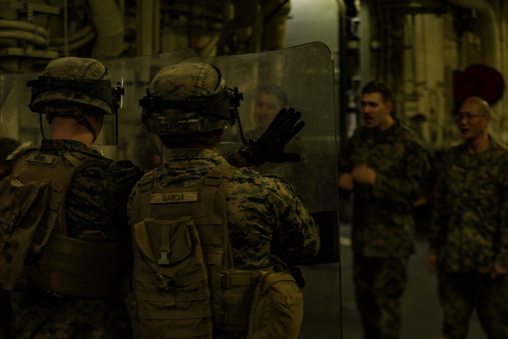 Hold the line: Marines practice riot control aboard USS America