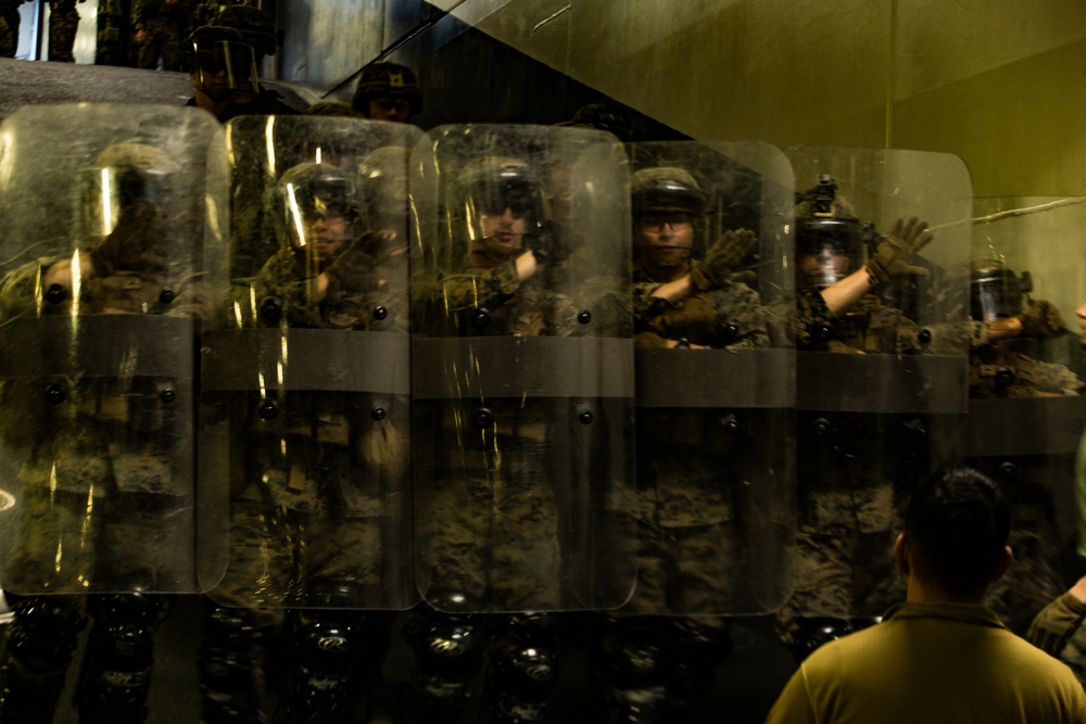 Hold the line: Marines practice riot control aboard USS America