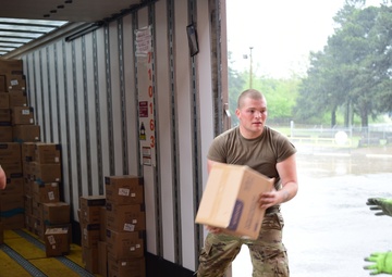 Arkansas National Guardsmen unload trailers with PPE for Arkansas counties
