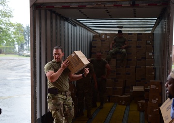 Arkansas National Guardsmen unload trailers with PPE for Arkansas counties