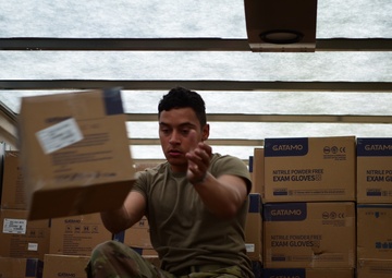 Arkansas National Guardsmen unload trailers with PPE for Arkansas counties