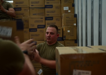Arkansas National Guardsmen unload trailers with PPE for Arkansas counties