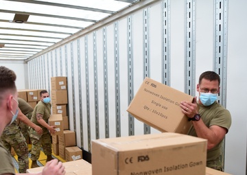 Arkansas National Guardsmen unload trailers with PPE for Arkansas counties