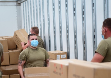 Arkansas National Guardsmen unload trailers with PPE for Arkansas counties