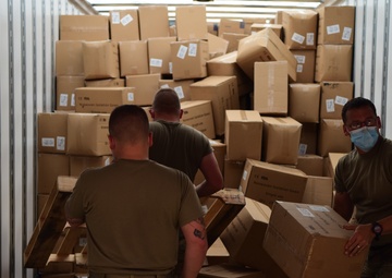 Arkansas National Guardsmen unload trailers with PPE for Arkansas counties