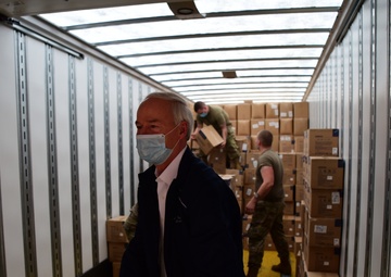 Arkansas National Guardsmen unload trailers with PPE for Arkansas counties