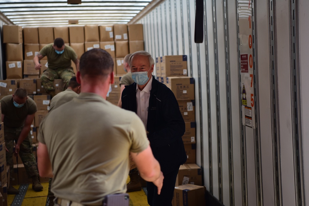 Arkansas National Guardsmen unload trailers with PPE for Arkansas counties