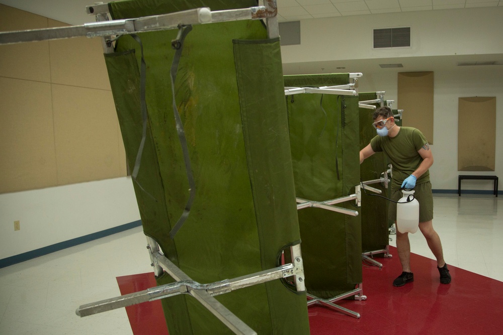 3rd Medical Battalion Corpsman sanitize facility for USS Theodore Roosevelt Sailors