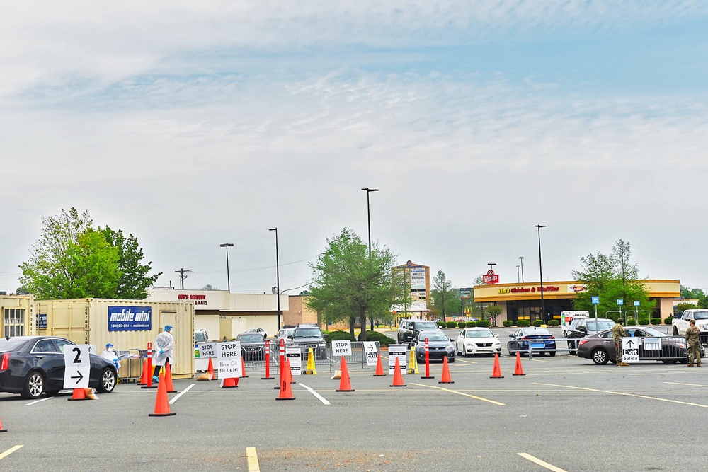 La National Guard assist with traffic control for drive through testing