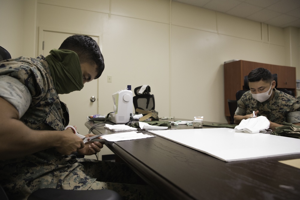 Mask Marines | Marines from Camp Operations aid in the making of masks for service members