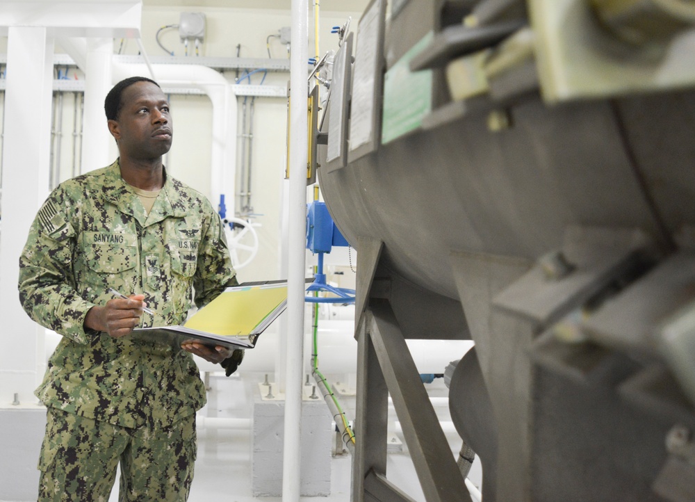 Aviation Boatswain’s Mate (Fuels) 2nd Class Lamin Sanyang Checks Fuel Levels