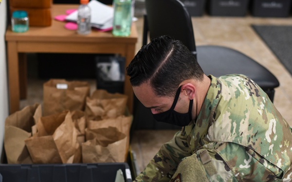 Cannon Airmen volunteer in helping families w/ medication drop off point