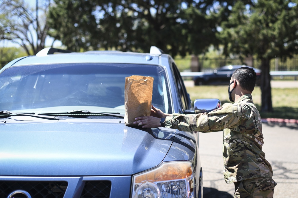 Cannon Airmen volunteer in helping families w/ medication drop off point