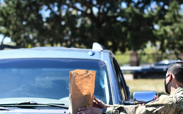 Cannon Airmen volunteer in helping families w/ medication drop off point