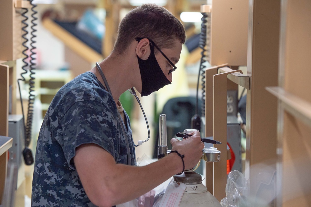 Sailor Checks Oxygen Tank