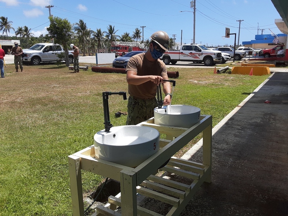 U.S. Navy Seabees with NMCB-5’s Detail Tinian build sinks for health care workers