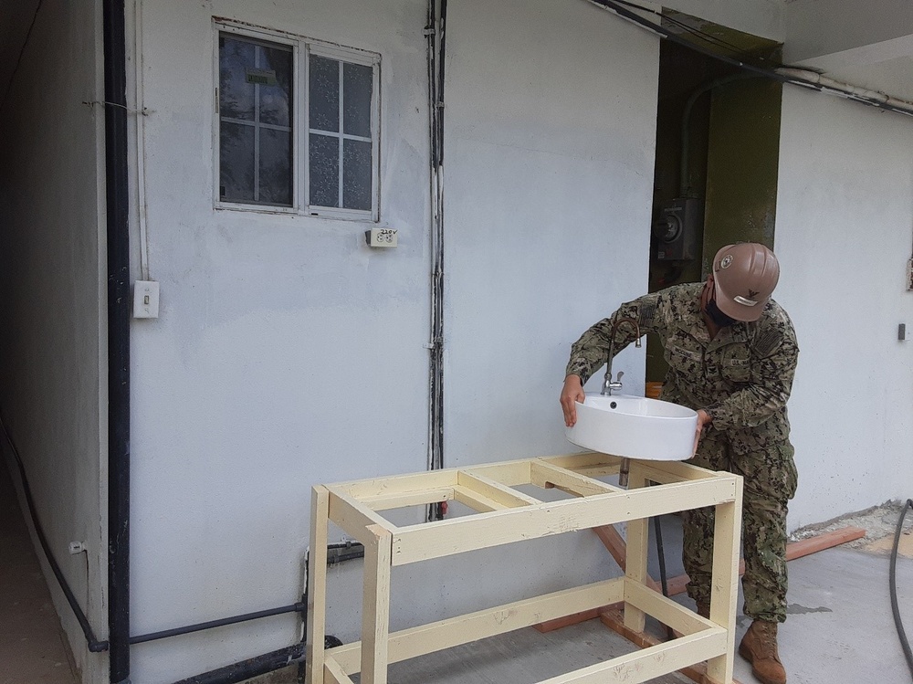 U.S. Navy Seabees with NMCB-5’s Detail Tinian build sinks for health care workers