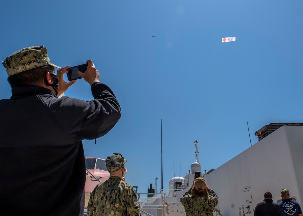 USNS Mercy Sailors Take Photos of Thank You Sign