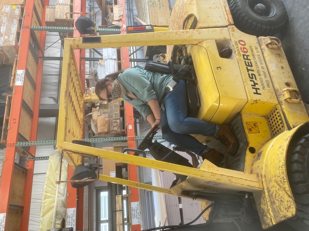 Forklift operator wears mask to protect from possible exposure to coronavirus