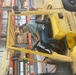 Forklift operator wears mask to protect from possible exposure to coronavirus