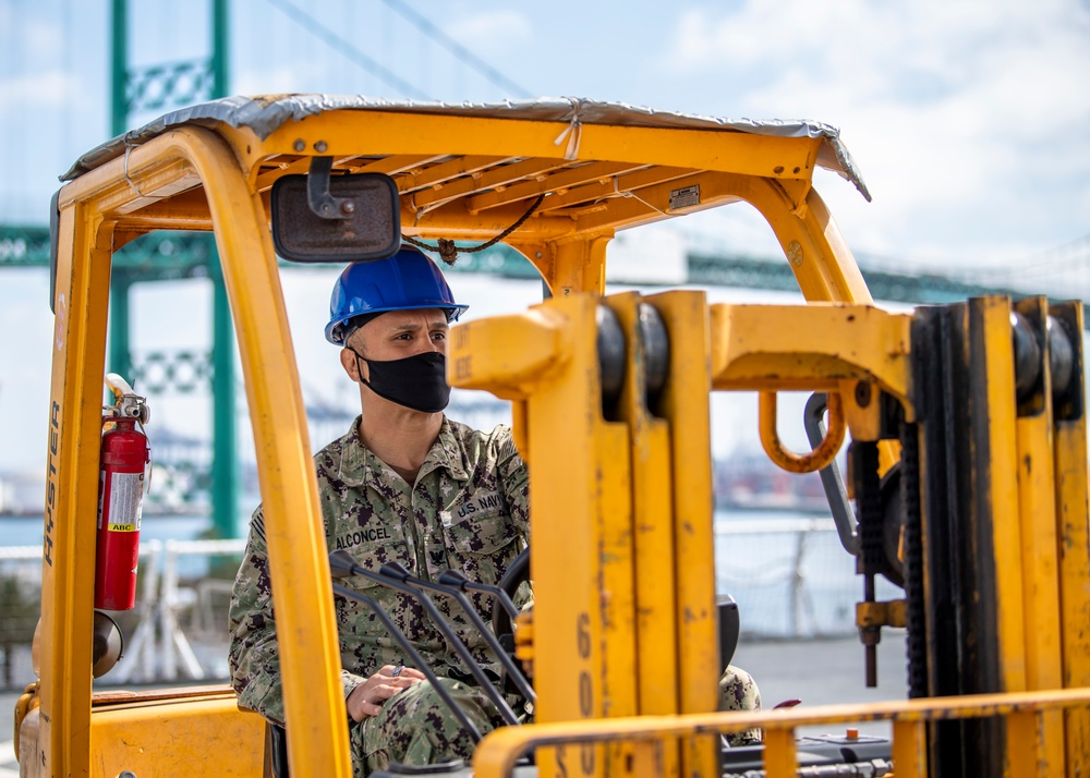 USNS Mercy Sailor Operates Forklift