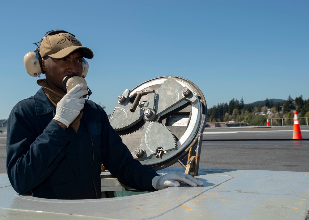 Nimitz Sailor Communicates To Panel On Flight Deck