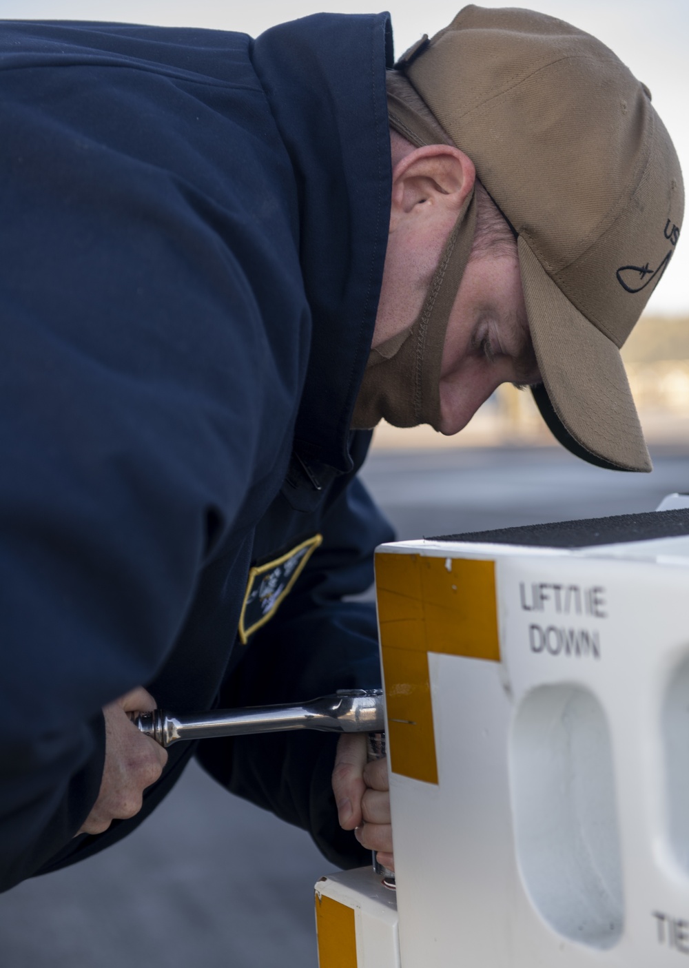 Nimitz Sailor Installs Bolts Onto Tow Tractor