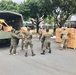 Service members load cot pad boxes for donation