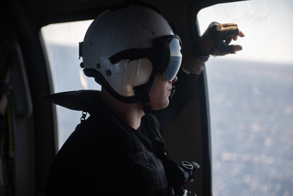 U.S. Sailor observes flight operations