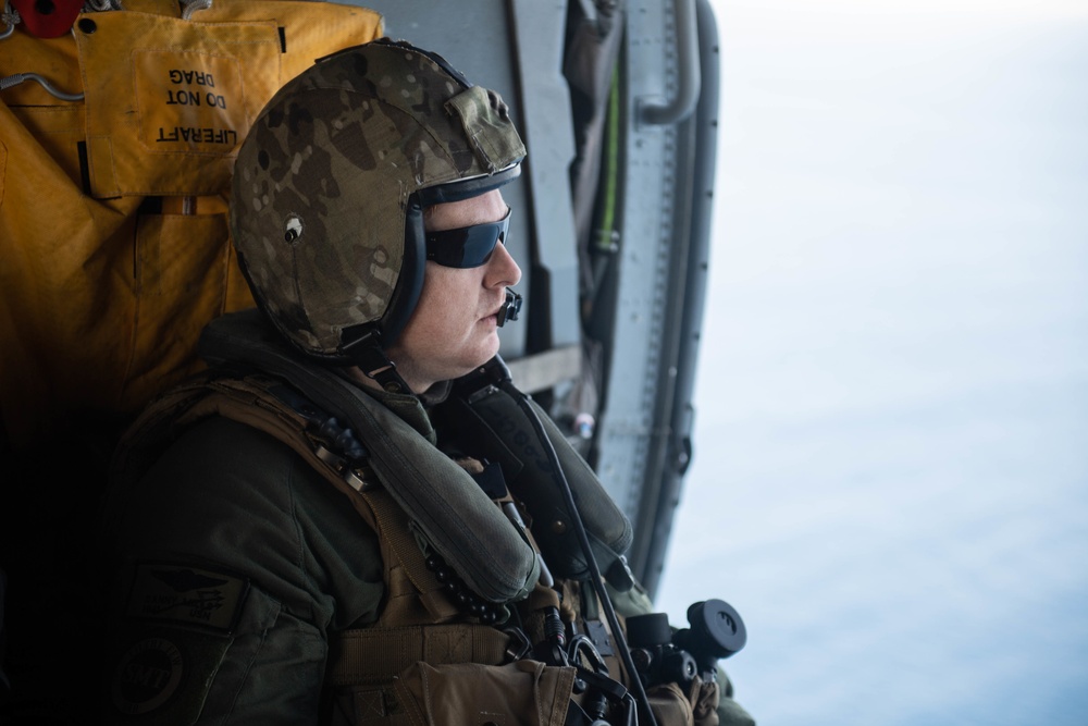 U.S. Sailor observes flight operations