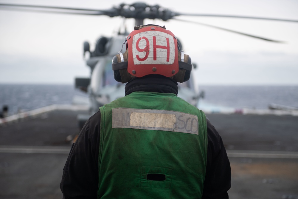 U.S. Sailor prepares to launch MH-60S Sea Hawk