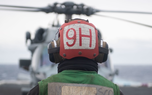 U.S. Sailor prepares to launch MH-60S Sea Hawk