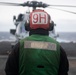 U.S. Sailor prepares to launch MH-60S Sea Hawk