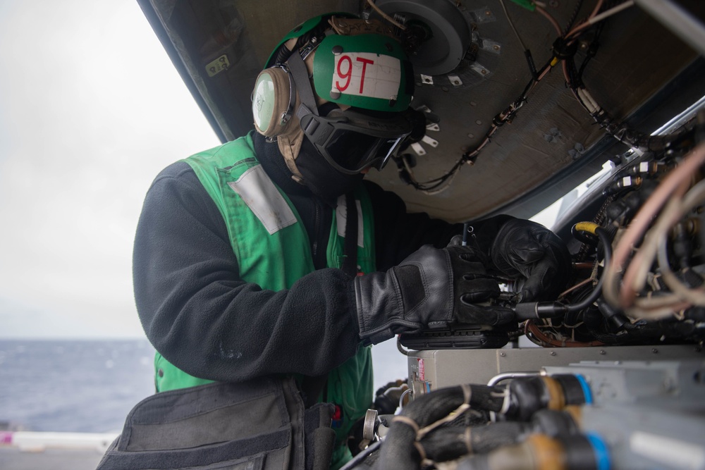 U.S. Sailor inspects MH-60S Sea Hawk