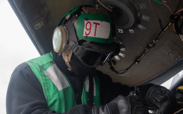 U.S. Sailor inspects MH-60S Sea Hawk