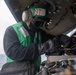 U.S. Sailor inspects MH-60S Sea Hawk