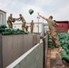 Soldiers unload and stack sandbags at Erbil Air Base