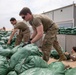 Soldiers unload and stack sandbags at Erbil Air Base