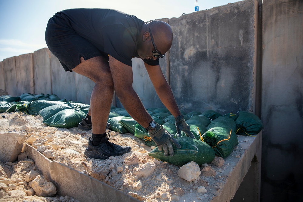 Soldiers fill sandbags and increase force protection measures