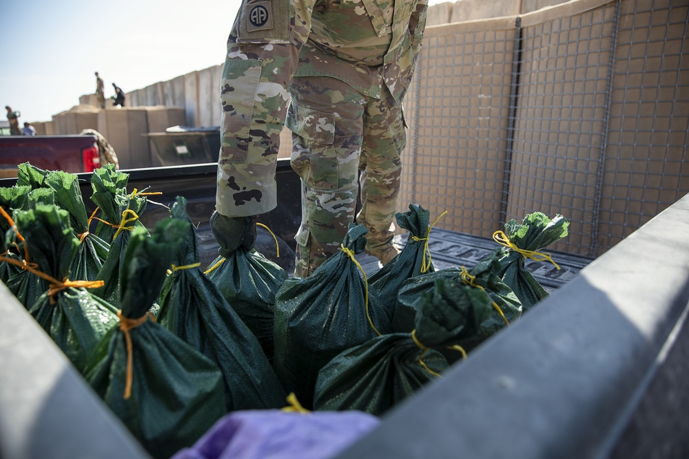 Soldiers fill sandbags and increase force protection measures