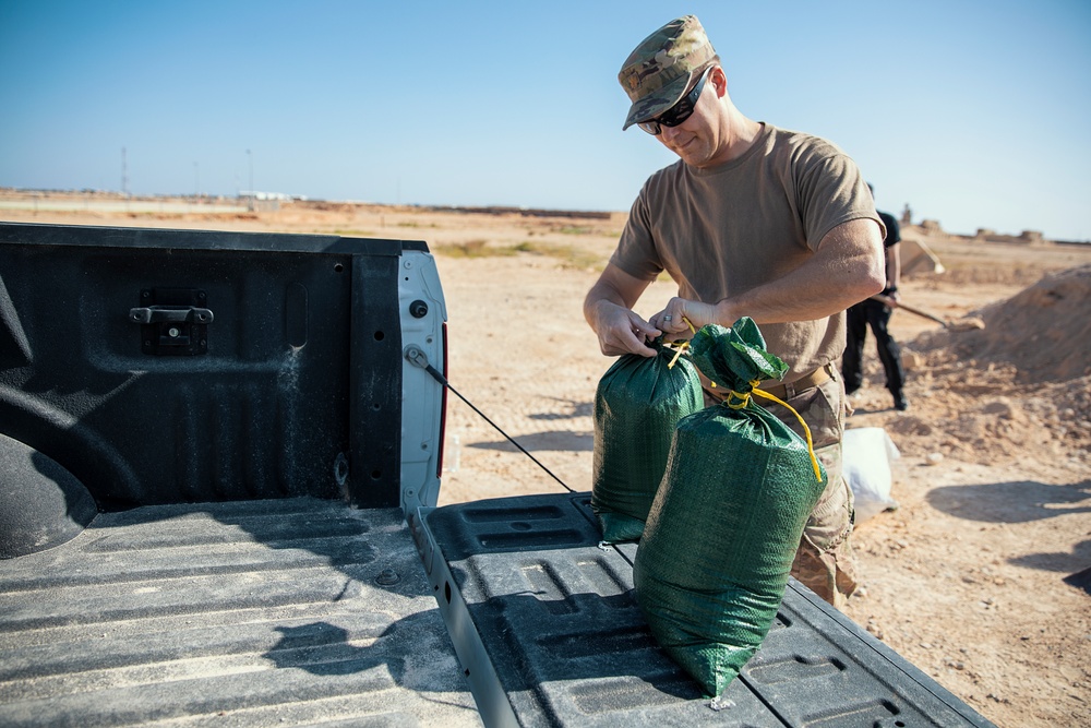 Soldiers fill sandbags and increase force protection measures